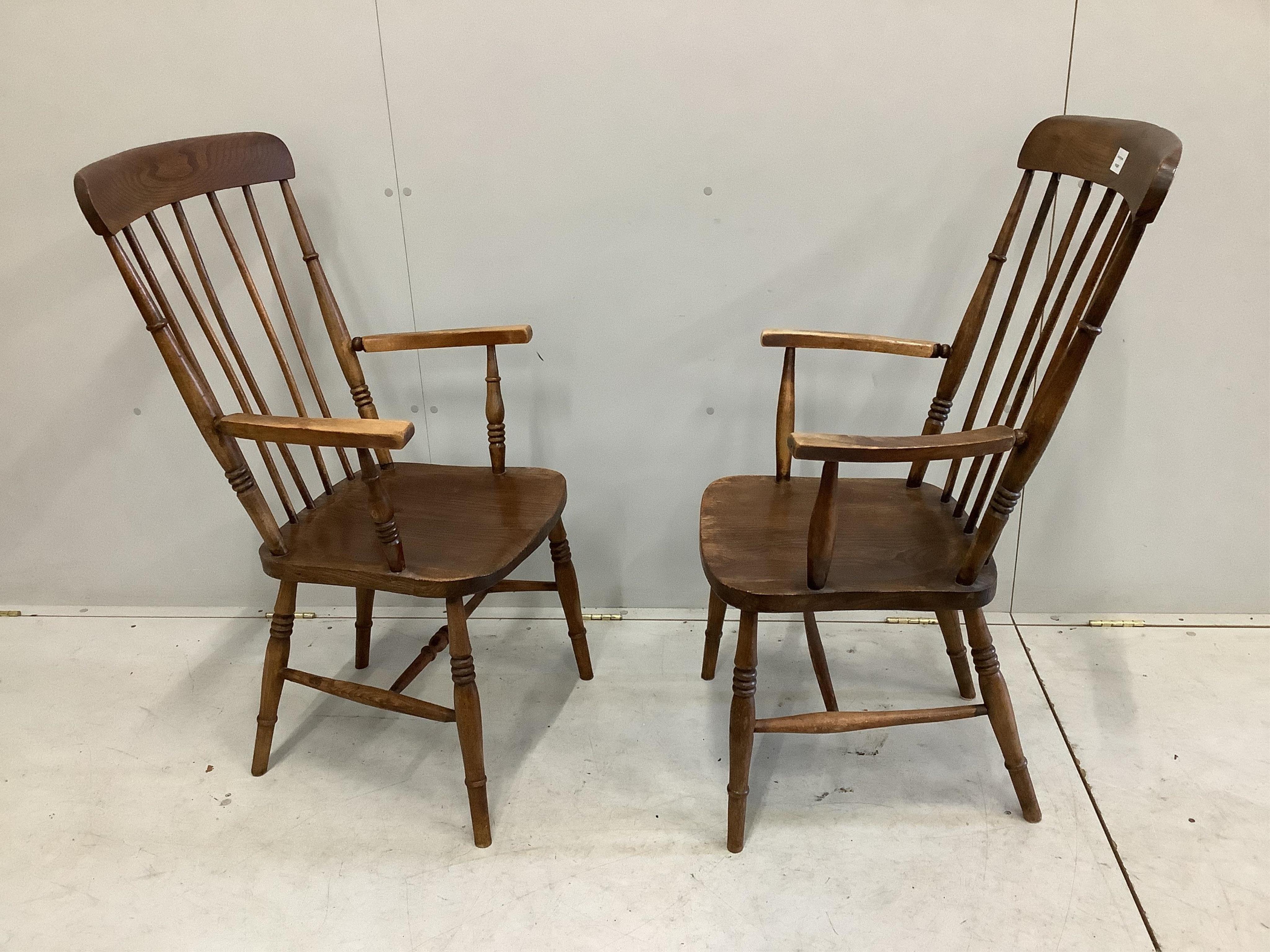 A pair of mid 19th century ash, elm and beech Windsor comb back armchairs, width 52cm, depth 44cm, height 105cm. Condition - fair